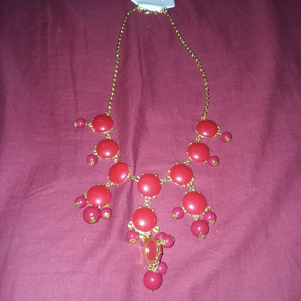 Gold-tone necklace with plastic red accents